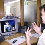 Deaf or HOH person and video interpreter communicate in ASL