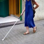 Student walking with white cane